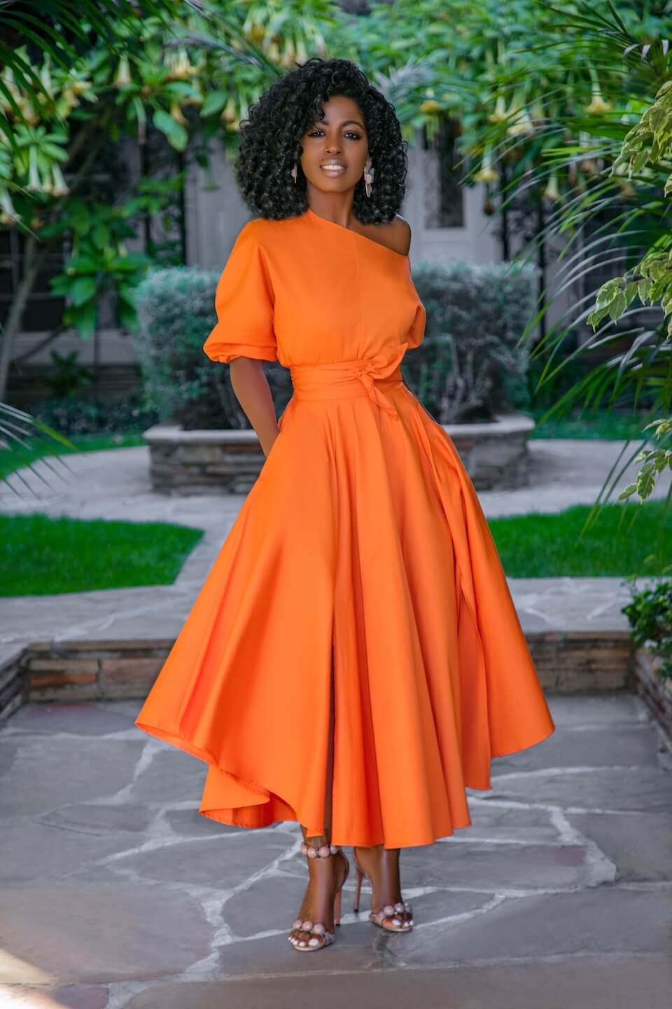 Folake in a vibrant orange dress